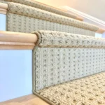 Close-up of beige carpet runner with fabric binding