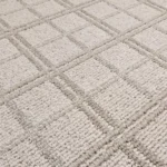Close-up of beige plaid textured carpet.