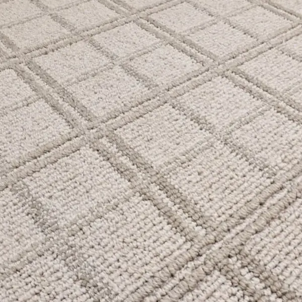 Close-up of beige plaid textured carpet.