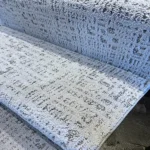 Close-up of textured gray and white stair carpet