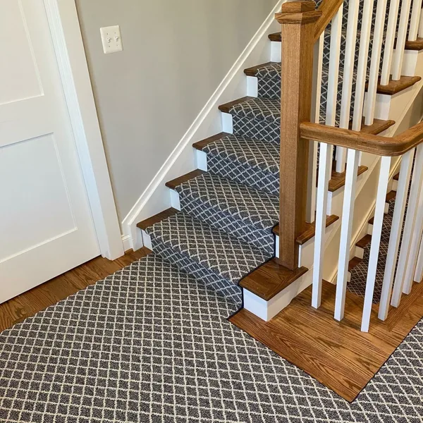 Dark grey diamond trellis carpet on stairs and floor.