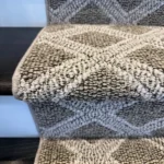 Detail of grey and white woven carpet on a stair nose