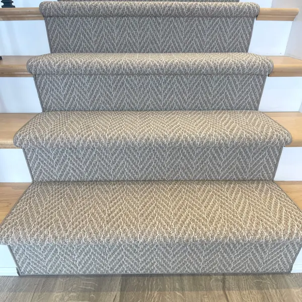 Front view of patterned carpet runner on wood stairs