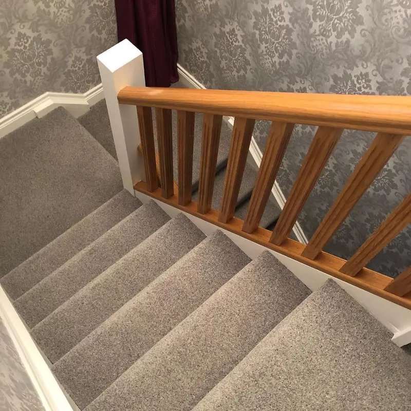 Grey textured carpet installed on a landing and stairs