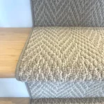 Herringbone carpet runner on wood stairs close-up