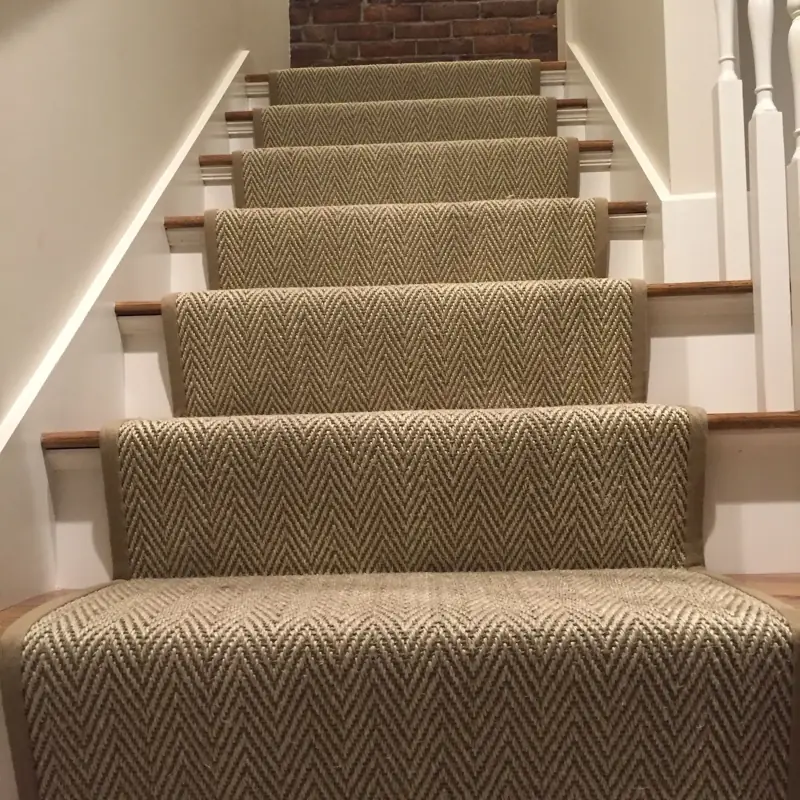 Herringbone jute runner on white and wood stairs