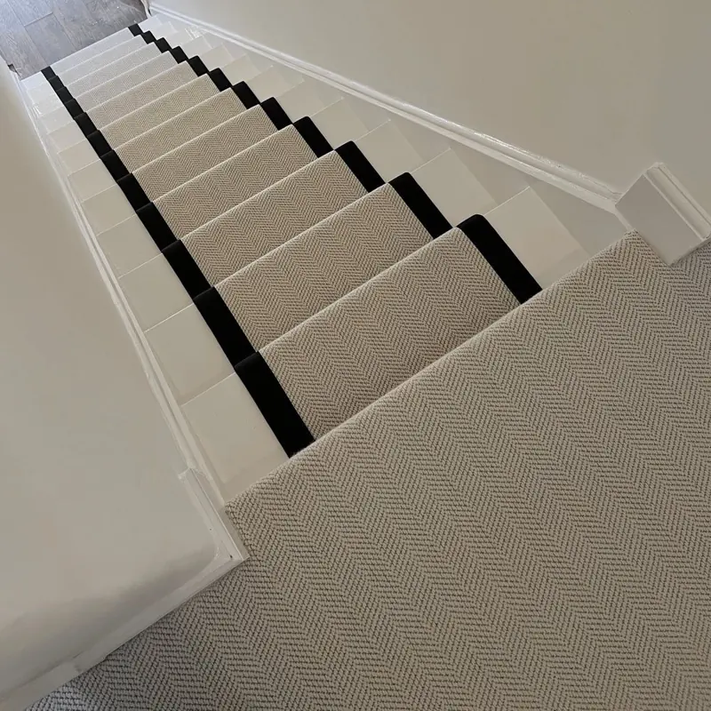 High-angle view of a beige runner with black edges.