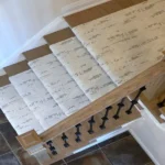 High-angle view of carpet runner and wood banister