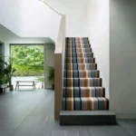 Modern staircase with colorful striped carpet runner