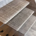 Patterned carpet treads on wooden staircase