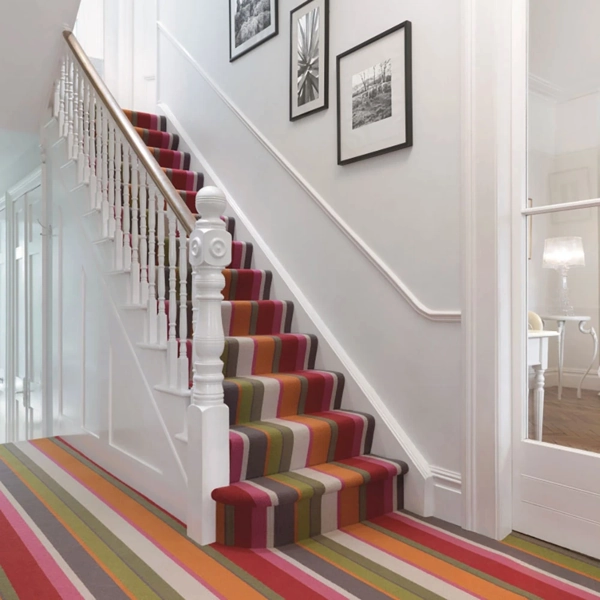 Staircase with multicolored striped carpet runner