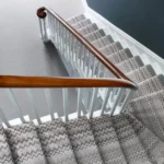 Staircase with zigzag patterned carpet runner in gray and beige