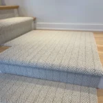 Textured carpet runner on a wooden stair landing